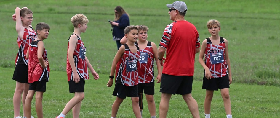 six cross country boys talking to coach